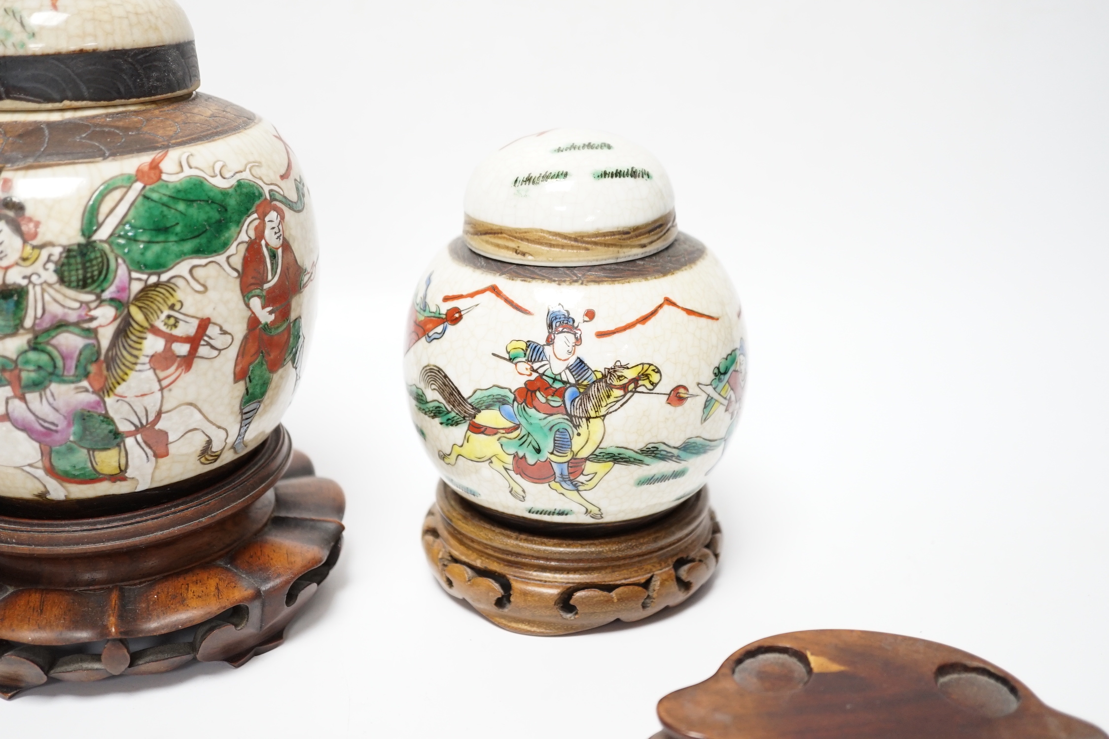 A Chinese famille verte vase, Kangxi period (cut down) and three Chinese polychrome jars with hardwood stands, tallest 19cm